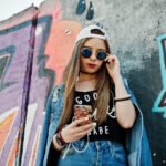 stylish casual hipster girl in cap, sunglasses and jeans wear, l