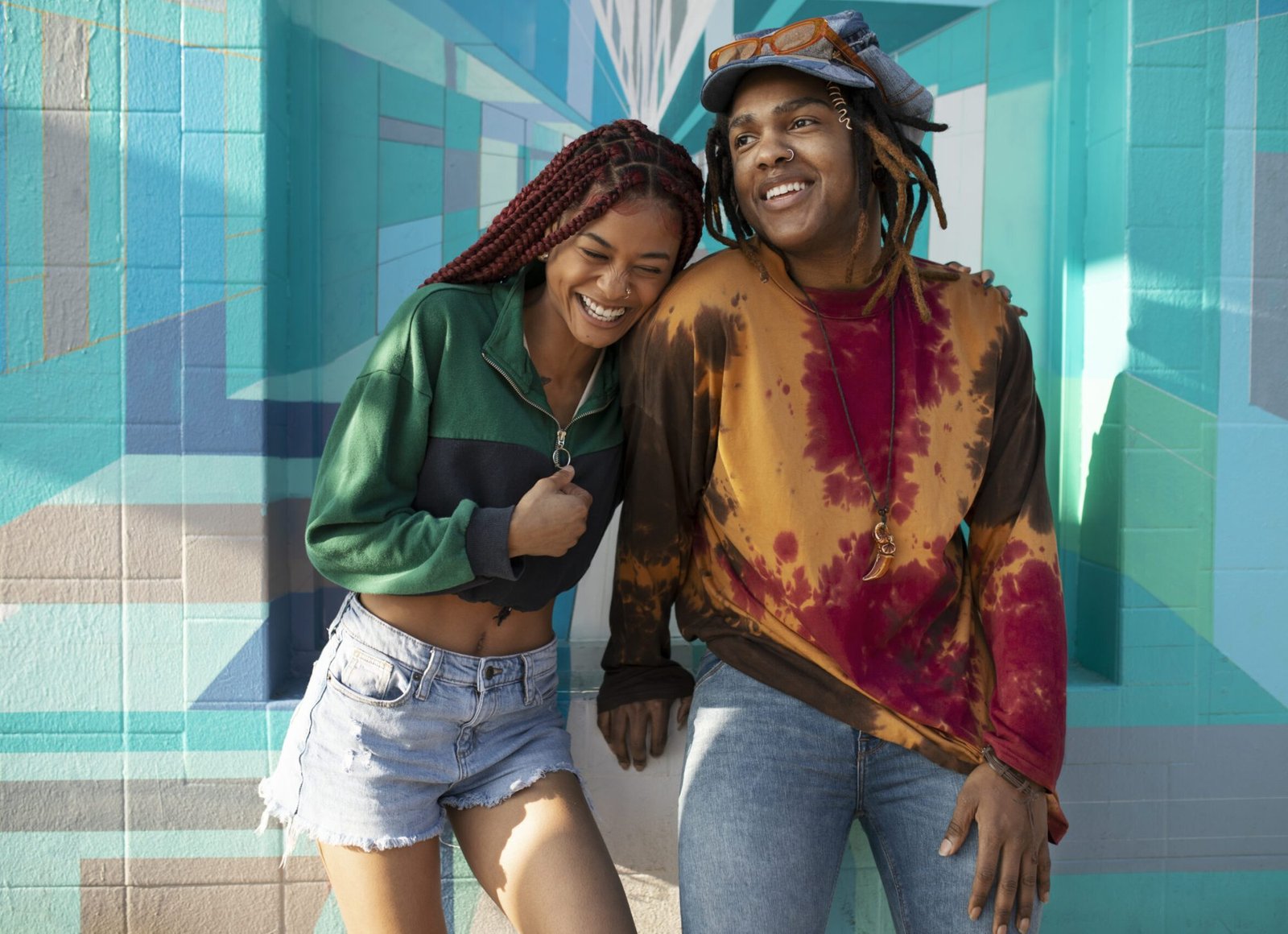 two friends posing smiling outside city